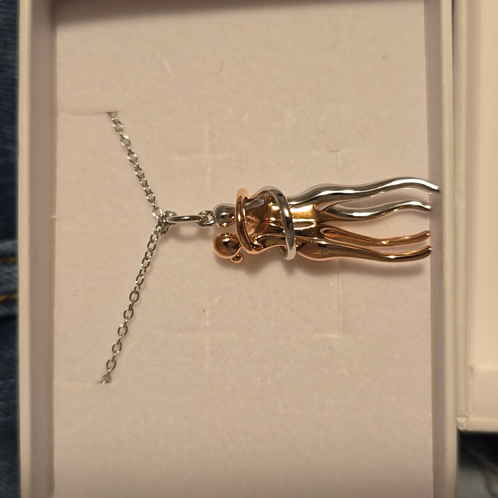 Embracing couple necklace